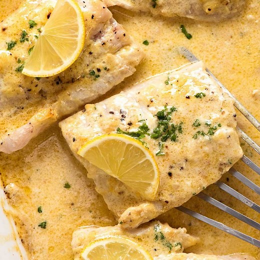 This Baked Fish recipe comes with a Lemon Cream Sauce and is made in ONE baking dish!!! https://www.recipetineats.com/baked-fish-with-lemon-cream-sauce/ | RecipeTin