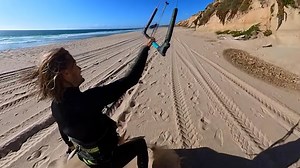 Kite Surfer Soars From Sandy Cliff!