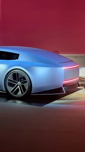 Jaguar has unveiled the Type 00 concept, a two-door coupe that hints at the styling of the brand's electric four-door grand tourer coming in 2026. The Type 00 has a long hood and fastback roofline, with sharp lines and a repeating "strikethrough" motif. The cabin is influenced by architecture, with a stone plinth supporting the seats and structural brass bars that divide the interior. | Car and Driver