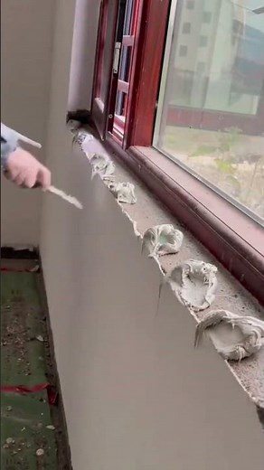 installing beautiful white stone window sill manually using hands