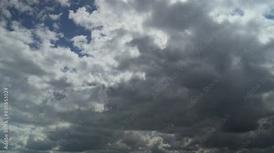 Cumulonimbus clouds evolving as they sweep across the sky with stormy grey undersides. Time lapse 60x.