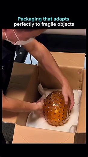 AI. Tech. The next evolution. on Instagram: "An industrial packaging system designed to solve a very old problem: how to ship fragile items without guessing where impact will happen. The process is simple, but precise. A cardboard carton is placed under the machine, which dispenses a paper layer followed by liquid foam. Within seconds, the foam expands and hardens, forming a custom bottom cushion shaped exactly to the box. A fragile glass item is then placed on top, and the sequence is repeated 