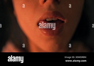 Closeup lips caucasian actor in warm lowlight, experimental mouth shapes, tongue rolls and expressive breathing, theatrical mood Stock Video Footage - Alamy