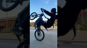 Electric dirtbike wheelie stunts in the city