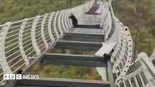 China: Man left dangling from bridge after glass breaks