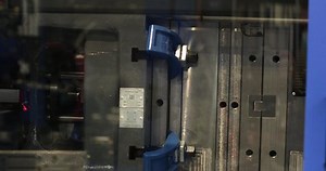 clip-1083712999-close-automated-injection-molding-machine-producing-plastic