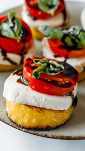 Grilled Polenta Caprese Appetizer is topped with fresh mozzarella, basil and tomato, and drizzled with a balsamic glaze! Perfect summer bites! YES, PLZ! recipe link in BIO! https://reluctantentertainer.com/grilled-polenta-caprese-appetizer/ ❤️ #reluctantentertainer #ripolivianewtonjohn #grilledpolenta #letmebethere | Reluctant Entertainer