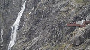 viewing platform at a waterfall in the mountain landscape at the Trollstigen scenic road in the mountains of Norway.
