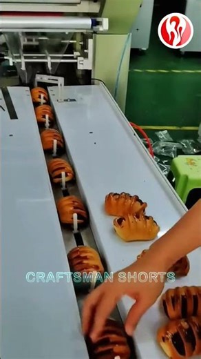 Bread | The finished bread is placed on a packaging machine.