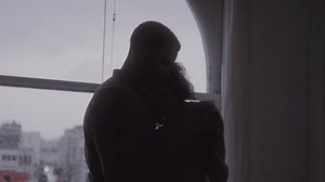 Silhouette of an Intimate Moment Between a Couple in Front of a Window