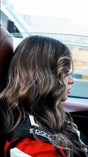 Girl drives convertible through busy city streets