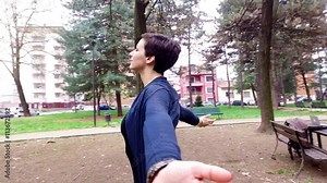 Going around a yong beautiful caucasian woman spreading arms wide open, feeling free with eyes closed – serene, carefree, girl power concept