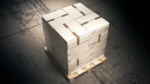A stack of cardboard boxes on a pallet in the warehouse waiting for a forklift.