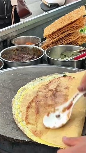 make savory crepes by adding sauce to all parts then rolling and cutting them
