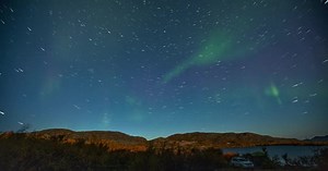 Aurora Borealis. Timelapse of the northern lights with its reflection in the lake