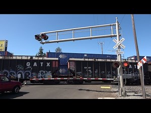 UP 9077 Stack Train South Stops And Meets UP 8835 Manifest Train North, 14th Ave. Railroad Crossing