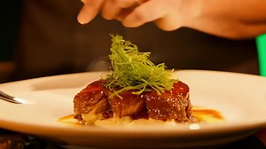 Download A chef plating a gourmet dish with precision. Green screen backdrop. Warm, ambient lighting to reflect a high-end restaurant. for free