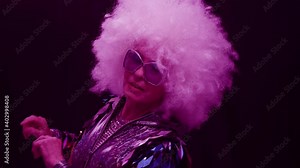 Senior woman dancing in disco with headphones