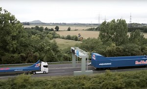 The World's First Motorcycle Flip Between Two Moving Trucks