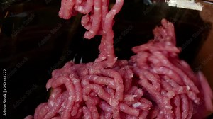 Kitchen electric meat grinder shreds meat into strips of minced meat...Unmodified camera color.