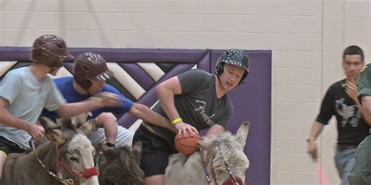 James Monroe High School seniors play a game of donkey basketball
