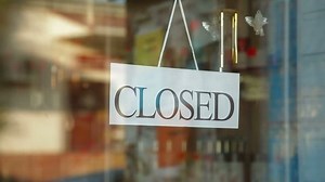 clip-2867836-business-owner-turns-sign-closed-open-front