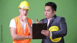 Scandinavian man construction worker and Asian businessman working together