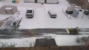 Brendan adding snow to his and Justin truck for a little weight | Arch Advanced Pain Management