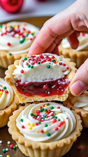 Christmas Cherry Cream Tarts | Buttery, Festive & Filled with Joy 🎄 These little beauties are pure holiday magic — buttery tart shells, sweet cherry filling, and fluffy cream topping all dressed up in sprinkles! 🎅 Ingredients: For the tart shells: 1 cup unsalted butter, softened ½ cup powdered sugar 1 egg yolk 2 cups all-purpose flour 1 tsp vanilla extract For the filling: 1 cup cherry pie filling (or homemade cherry compote) 1 tbsp cornstarch (if using compote, to thicken) For the cream toppi