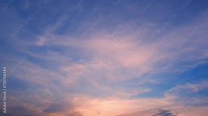 4K : Sunset sky time lapse : Timelapse video captures a sunset sky adorned with vibrant hues. Wispy clouds gracefully dance across the horizon, painting a picturesque scene of tranquility and beauty.