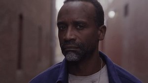 Portrait of a Middle Aged Homeless Man Standing in a Brick Alleyway