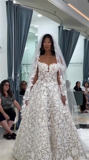 Eve of Milady on Instagram: "Where couture meets the aisle. ✨The 2026 Eve of Milady Collection is an ode to structure, sparkle, and silhouettes that own the room. From sculpted bodices to fluid trains and intricate floral appliqué, every gown is designed for the bride who doesn’t follow trends, she sets them. This moment from our recent showcase celebrating @bridalreflectionsny proves: bridal fashion is entering a whole new era. 💋#eveofmilady Hair & Makeup: @victoriaelizabethofficial @katelynve