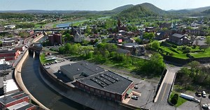 Cumberland Maryland. Aerial of Potomac River and West Virginia Appalachian Mountains. Church steeple downtown buildings.