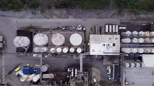 Industrial chemical processing plant with tanks and pipes, transport trucks, rail transport, heavy industry, economy. 4K 24FPS