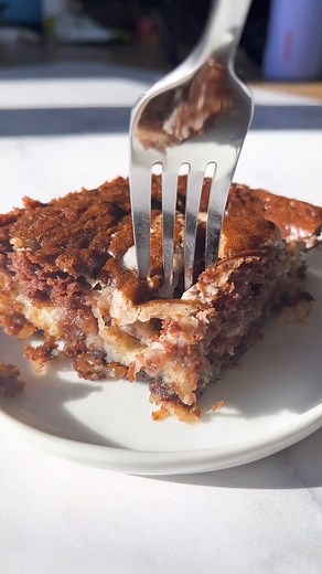 Earthquake cake is one of the best cakes to serve for a party. It cracks open when baked, hence the name! 😋 To add to its goodness, you don’t even have to frost earthquake cake because the cream cheese mixture becomes a layer of frosting INSIDE the cake. #earthquakecake #easycakerecipe #cakemixrecipe | The First Year