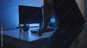 Man is working at professional computer with backlight. Clip. Man is working at computer with backlight. Programmer or gamer with stylish computer setup