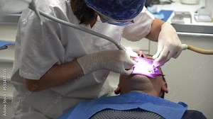 Dental clinic, doctor performing an endodontic operation on a patient