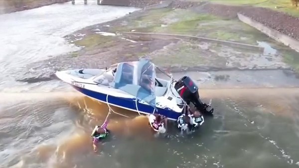 Watch: Men cling to boat as it dangles over edge of 130ft dam
