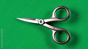 Pair of scissors, isolated against a vibrant green screen, showcases various stages of opening and closing, highlighting the sharp blades and sturdy handles in detail