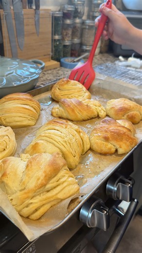 Quick Croissants 🥐 Mix 1 tbsp yeast, 1 egg, 2 tbsp melted butter, ⅓ cup warm water, 1 1/2 tsp salt, 3 tbsp sugar, and 3 cups of flour. Cover with airtight lid, and rest for one hour. Flatten one stick of butter between parchment paper sheets. Roll out croissant dough flat, add sheet of butter and fold the dough in thirds, covering the butter sheet. From here, roll out the dough, and fold three times. Repeat roll and fold 2 more times. Cut dough and roll into croissant shape. Bake for 20-25 minu