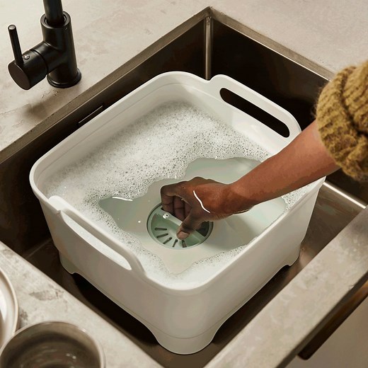 Our clever washing-up bowl has a removable plug to make straining and draining water much easier. ⁠ Shop yours here: https://bit.ly/JJ-WashDrain-Stone-Green | Joseph Joseph