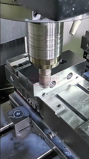 CNC milling machine cutting precision holes in metal