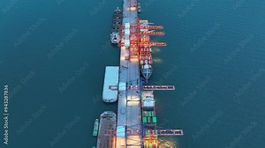 crane loading cargo container from truck to container ship in the international terminal logistic sea port concept freight shipping by ship. industry transportaion Stock Video