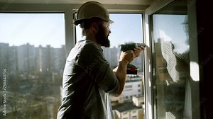 Worker replacing an old window with new plastic window . Apartment renovation