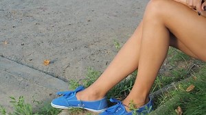 A girl with beautiful legs looks at the river.