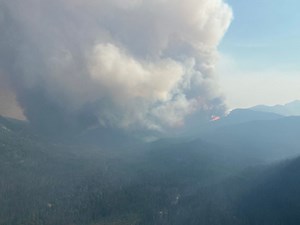 Crews keep close watch on one B.C. wildfire, as another delays school in northeast
