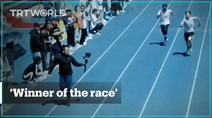 A college student serving as a cameraman during the 100-meter dash kept pace with sprinters despite the camera weighing over 4kg at the university sprint race in Shanxi, China | TRT World