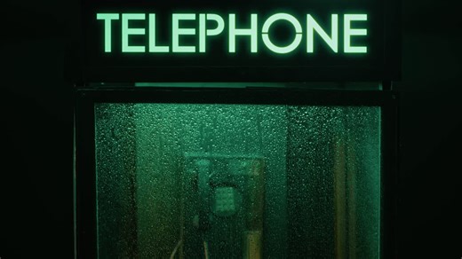Vintage Telephone Booth on a Rainy Night - Free Stock Video