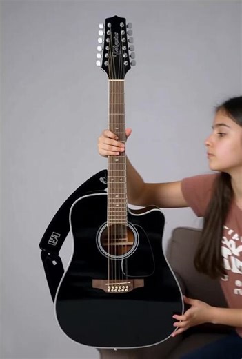 A girl playing strumming this exact 41 inch size guitar with a heavy duty strap attached to it and then switching from strumming to flatpicking as she is playing her favourite finger style song on it sitting on a couch in her own music studio