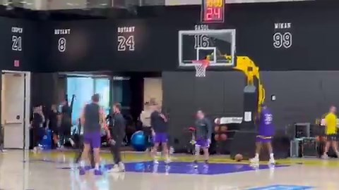 Luka Doncic doing some controlled, light movement shooting after practice under the watchful eye of Lakers assistant coach Greg St. Jean